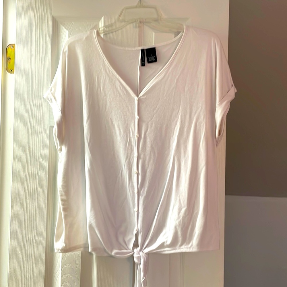 White cap sleeve top with a tie at the bottom